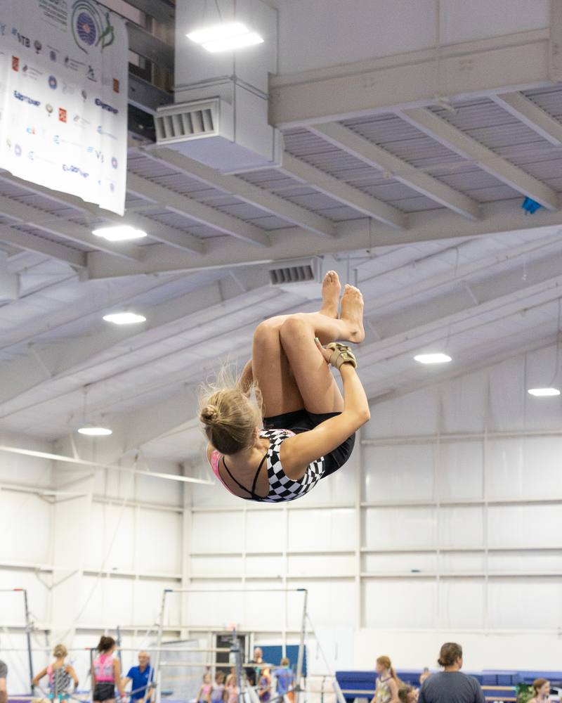 A tumbler in a tuck high above the floor